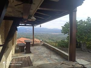a patio with a table and a view of a valley at ForestRock Studio FOR SALE TOO in Sparti