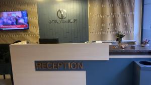 a reception desk in an office with a sign on it at Otel Yenikapı in Istanbul