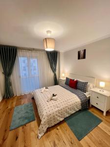 a bedroom with a bed with two stuffed animals on it at Apartamentos Prestige Malaga Suites III in Málaga