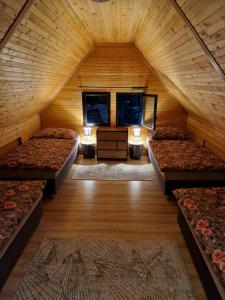 a room with four beds in a wooden cabin at Chata Tokarka - Richňavské jazerá in Štiavnické Bane