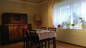 a dining room with a table and chairs and a window at Pension Remenar & Lorenz in Zeithain