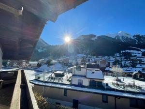 a view of a city with snow covered mountains at Sepp, Haus in Finkenberg