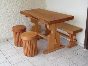 韋基奧港的聖塔露西的住宿－Maison Le Guetali，一张木桌,配有两张凳子和一张长凳