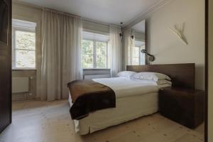a bedroom with a large bed and a large window at Hotel Skeppsholmen, Stockholm, a Member of Design Hotels in Stockholm