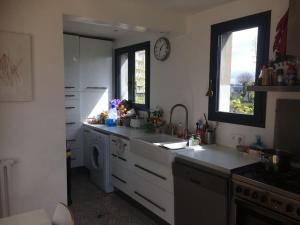 a kitchen with a sink and a washing machine at La maison sur la falaise in Nantes