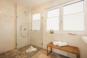 a bathroom with a shower and a bench and a sink at Sea Horse in Zingst +15 photos
