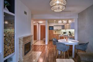 a kitchen and living room with a table and a fireplace at Donnovall Apartment in Donovaly
