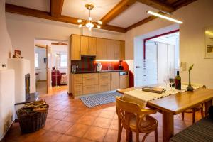 a kitchen with a table and a dining room at Villa Marienhof in Annenheim