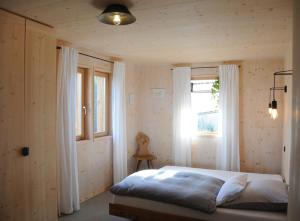 a bedroom with a bed and a window at Architektenhaus Reischl mit Sauna in Neubeuern