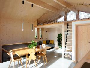 a room with a table and chairs and a couch at Architektenhaus Reischl mit Sauna in Neubeuern