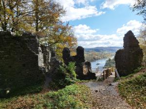 an old stone wall with a river and a bridge at Ropienka Ski in Ropienka
