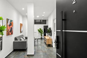 a living room with a couch and a table at Modern renovated 1 bedroom apartment w Bomb Shelter Central TLV M2 in Tel Aviv