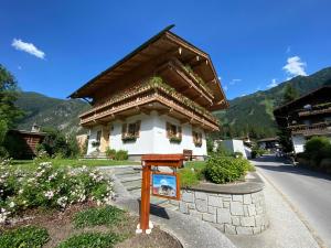 a small building with a sign in front of it at Maple Appartement in Mayrhofen