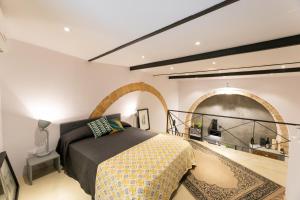 a bedroom with a bed in a room with an archway at Casa Teia, Exclusive Loft in Ortigia in Syracuse
