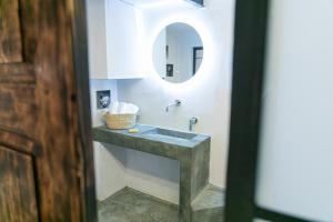 a bathroom with a sink and a mirror at Casa Teia, Exclusive Loft in Ortigia in Syracuse