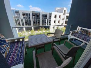 a balcony with a table and chairs and a view of a building at Zayed dunes in 6th Of October
