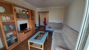 a living room with a couch and a coffee table at Sevilla Nervion Santa Justa in Seville