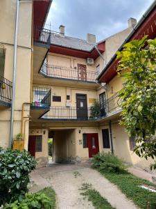 an apartment building with balconies and a courtyard at AA Apartman in Kaposvár