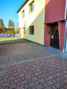 a building with a brick sidewalk next to a door at Apartment "Zur Rotbuche" in Lindau