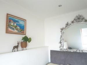 a mirror on a white wall in a room at Camden Town Apartment in London