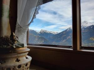 a window with a view of a mountain range at Waschhütte, Ferienhaus in Finkenberg