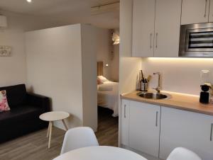 a kitchen with a sink and a room with a bed at Casas Natura Suites in Graus