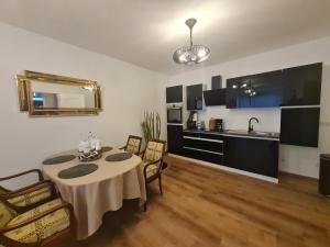 a room with a table and chairs and a kitchen at Nachtigallenthal 1 in Mechernich