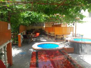 a patio with two pools and a table and chairs at Ani Hotel in Sisian