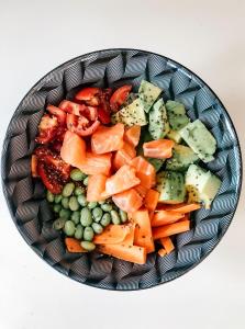 a bowl of food with carrots and other vegetables at Hotel Maremola in Pietra Ligure