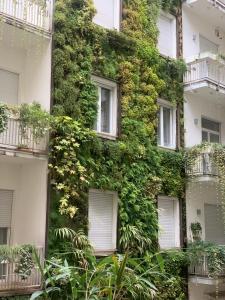an ivy covered building with windows and plants at Fifty Eight Milan Duomo in Milan
