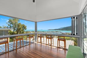 a balcony with chairs and a view of the ocean at Club Wyndham Airlie Beach in Airlie Beach