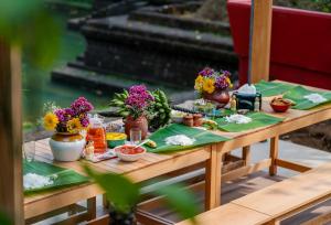 a picnic table with food and flowers on it at SaffronStays Amaya, Kannur - 300 years old heritage estate for families and large groups in Kannur