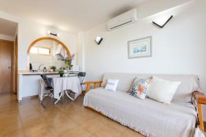 ein Wohnzimmer mit einem Bett und einem Tisch sowie eine Küche in der Unterkunft Córdoba con bonitas vistas in Salou