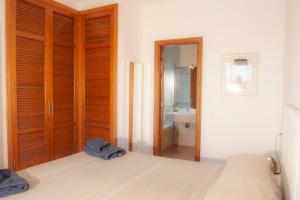 a bedroom with a bed and a bathroom with a sink at El jardín de Juanita - ROOMS in Playa Blanca