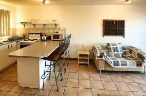 una cucina con bancone e un letto in una camera di Birds View Holiday Home a Langebaan