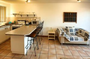 a kitchen with a counter and a bed in a room at Birds View Holiday Home in Langebaan