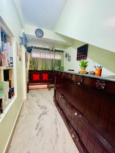 a living room with a large wooden wall at Moon Valley Cottage in Kovalam