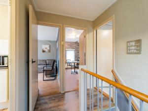 a hallway with a staircase leading to a living room at Comfortable upstairs apartment with a terrace in Eefde in Eefde