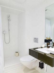 a bathroom with a toilet and a sink and a shower at VISIONAPARTMENTS Binzmühlestrasse 48 - contactless check-in in Zürich