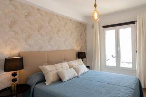 Postel nebo postele na pokoji v ubytování Flower Beach Suite 15