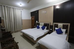 Voodi või voodid majutusasutuse Mahadev Hotel and Resorts toas