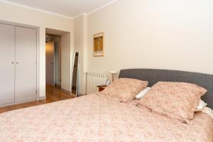 a bedroom with a bed with two pillows on it at Verde Mar Cascais Apartment in Estoril
