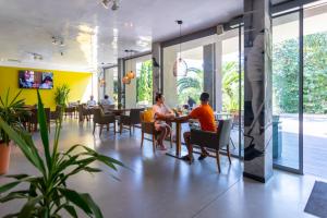 two people sitting at a table in a restaurant at Hotel Excelsior - All Inclusive in Golden Sands