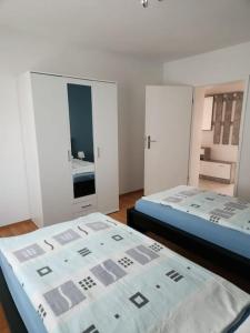 a bedroom with two beds and a mirror at Wohnung in Dortmund in Dortmund