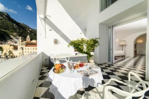 a room with a table with fruit on a checkered floor at Palazzo Don Salvatore in Amalfi