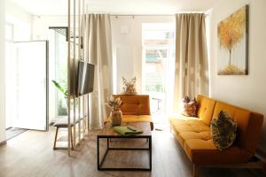 a living room with a couch and a table at Apartments zur alten Konditorei in Schwerin