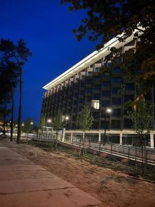 a large building with lights in front of it at Apartament Pobierowo PINEA in Pobierowo
