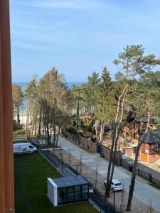 a view of a park from a window of a building at Apartament Pobierowo PINEA in Pobierowo
