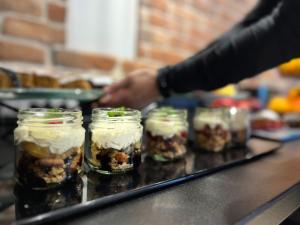 a group of jars filled with food on a counter at Hotel Krupnicza 30 in Krakow