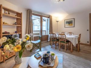 a living room with a table and chairs and a dining room at Appartement spacieux avec wifi, parking, balcon Sud à 10 min des commodités - FR-1-694-33 in Val dʼIsère